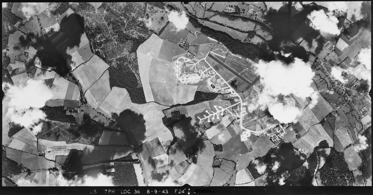 Aerial photograph of Ramsbury airfield looking west, the technical site is at the bottom right of the airfield; there is a dispersal area with a T2 hangar at the top left of the airfield, 8 September 1943. Photograph taken by 7th Photographic Reconnaissance Group, sortie number US/7PH/GP/LOC36. English Heritage (USAAF Photography).