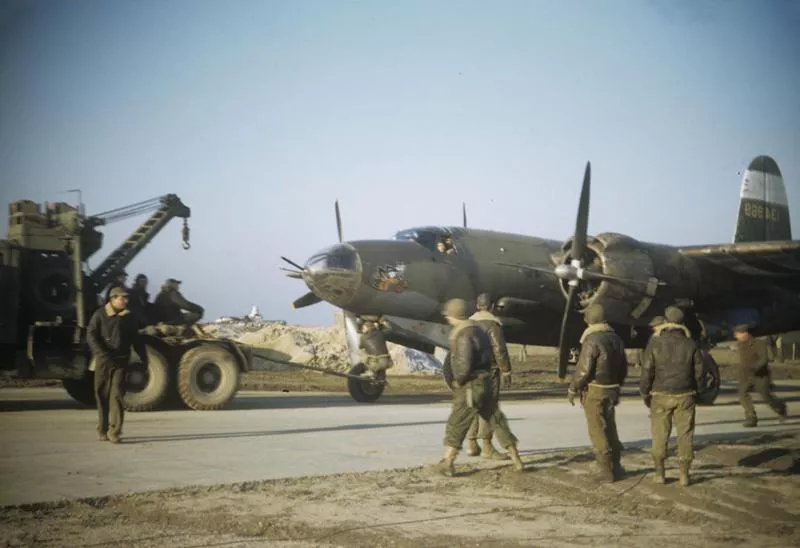 Ground personnel of the 323rd Bomb Group tow a B-26 Marauder (serial number 41-34969) nicknamed "Crew 13". Image via G Spradling. Written on duplicate slide: 'Single engine return, Laon, France, Dec 1944.'