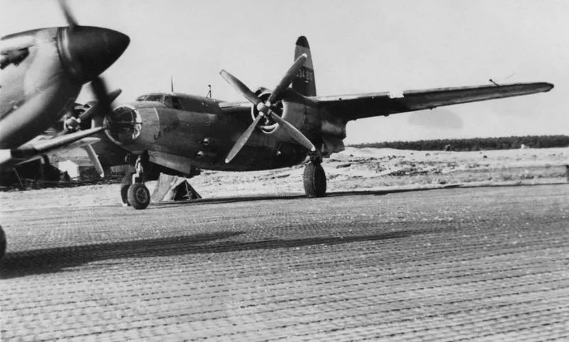 A Spitfire taxies past a B-26 Marauder (serial number 43-34210) nicknamed "La Palooza" of the 386th Bomb Group. Handwritten caption on reverse: 'RCAF.'
