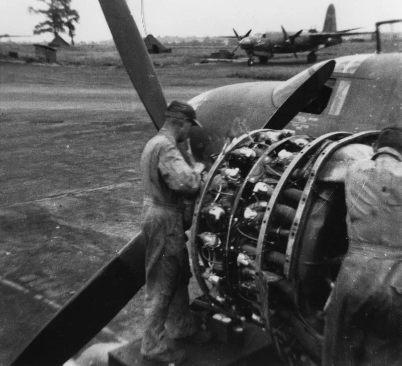 Ground personnel of the 387th Bomb Group work on the engine of a B-26 Marauder.